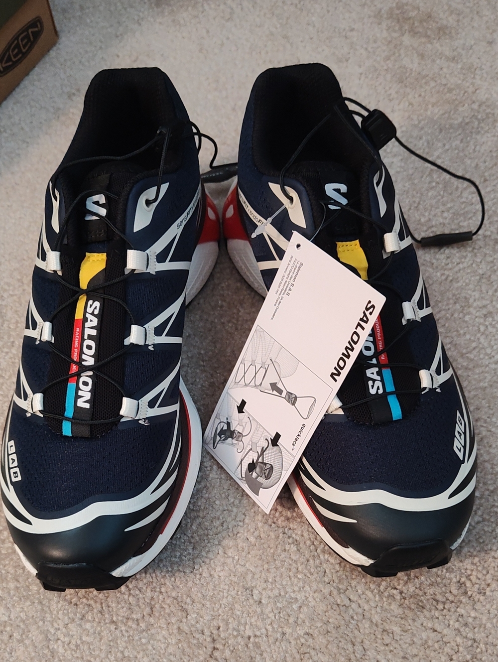 Salomon Black White Athletic Trail Shoes with Red and Yellow Accents